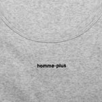 Close-up of a gray fabric with 'homme-plus' branding.
