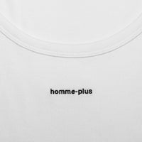 Close-up of a white shirt with 'homme-plus' branding.